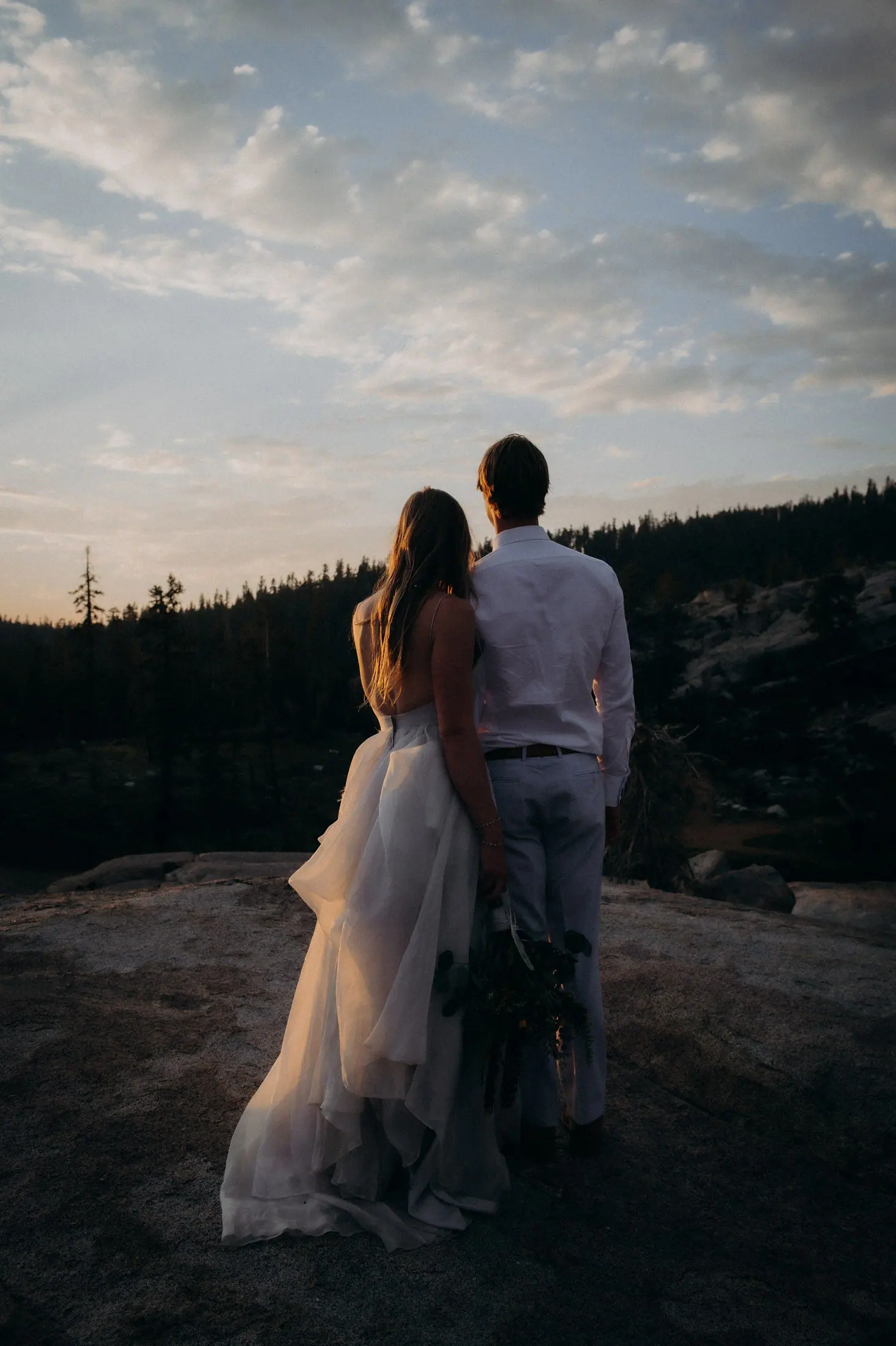 A couple on the granite dome at sunset.