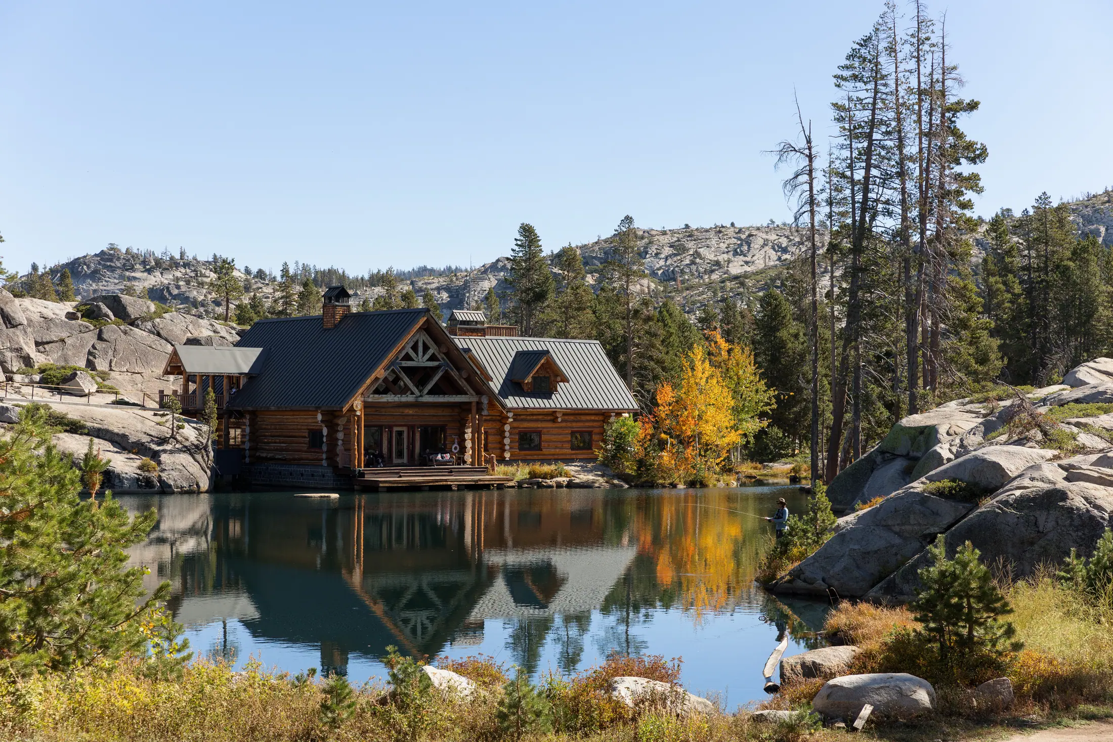 The lodge across the private lake in autumn.