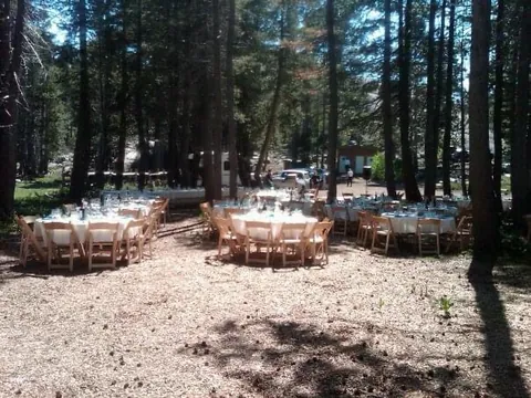 Tables set under the pines in an early season.
